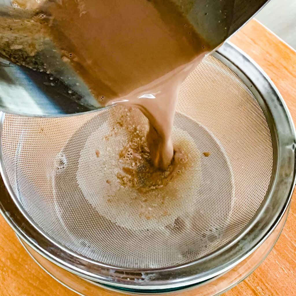 Straining out cocoa solids from steamed milk